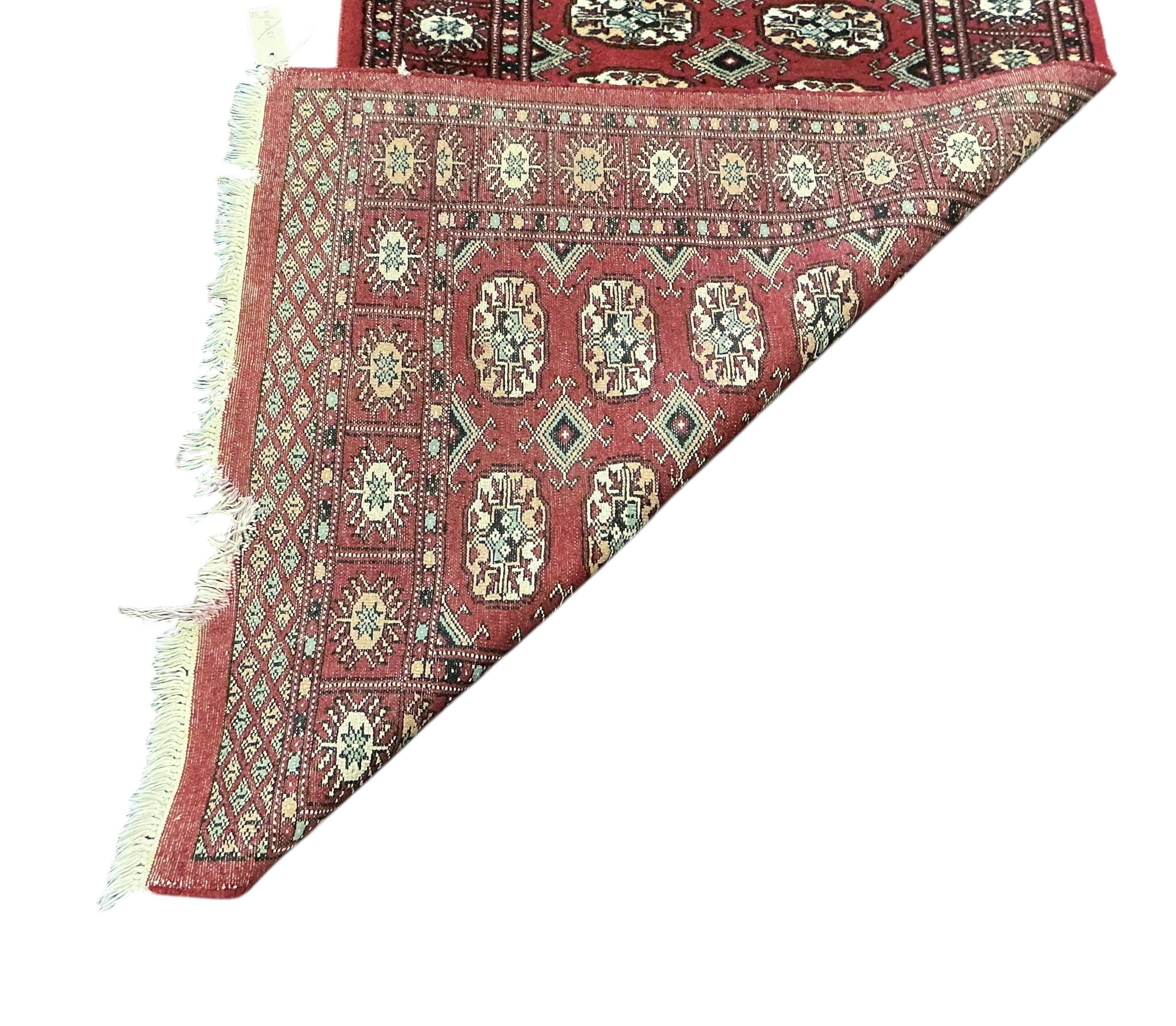 A Bokhara red ground runner and smaller rug, larger 300 x 78cm